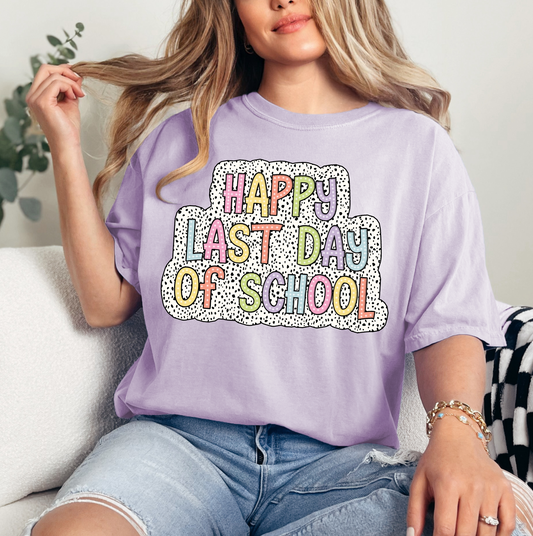 a woman sitting on a couch wearing a happy last day of school t - shirt