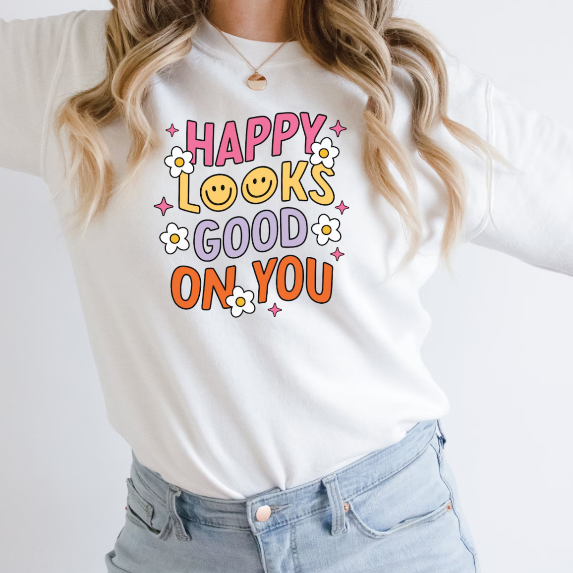 a woman wearing a happy looks good on you t - shirt