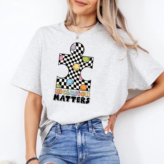 a woman wearing a t - shirt with a checkered design