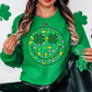 a woman wearing a green sweatshirt with shamrocks on it