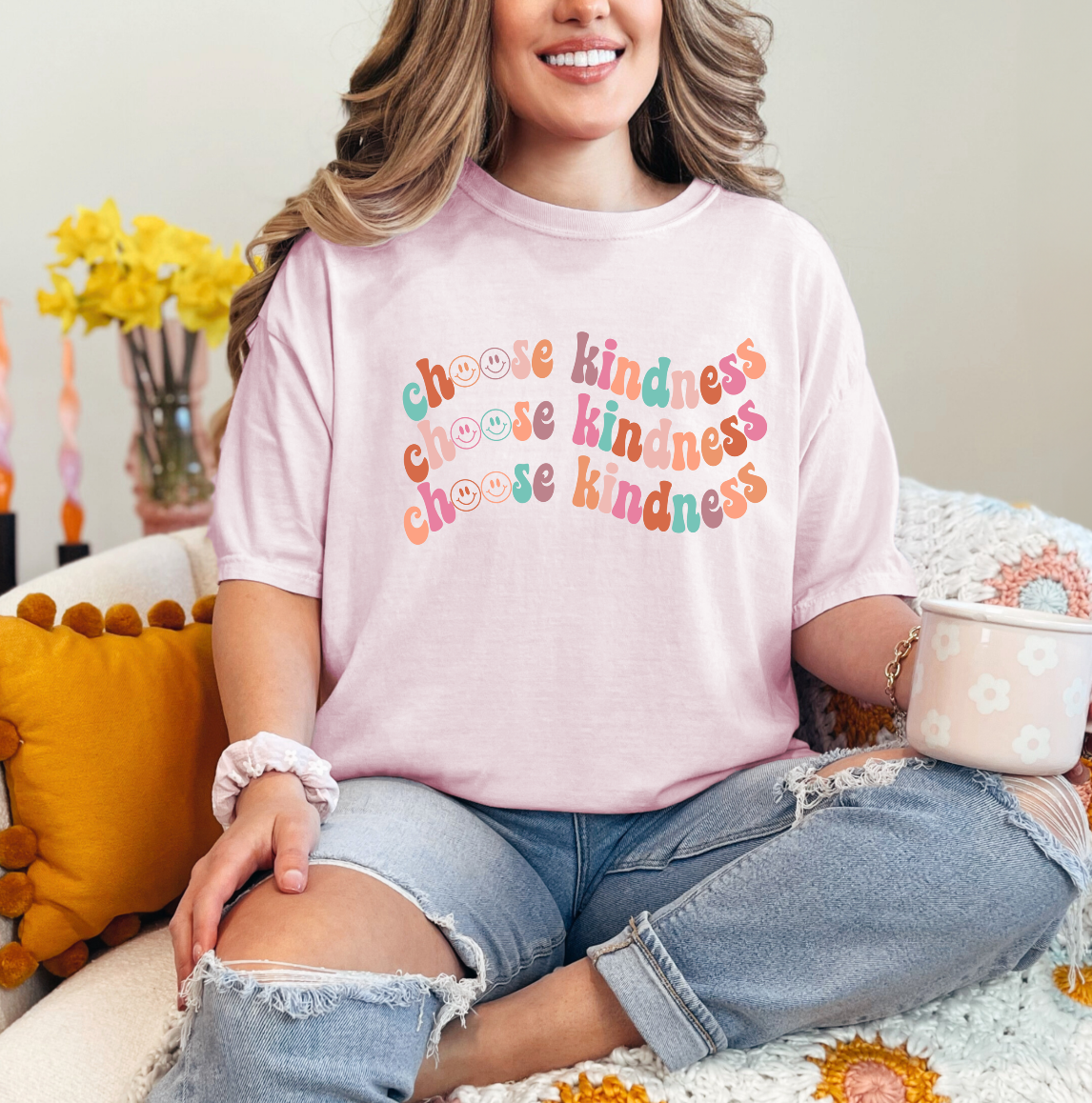 a woman sitting on a bed with a cup of coffee