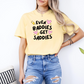 a woman wearing a yellow t - shirt that says even badies get saddles