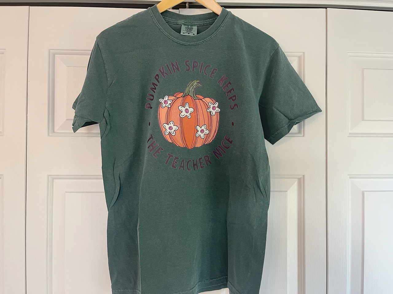 a green t - shirt with a pumpkin on it