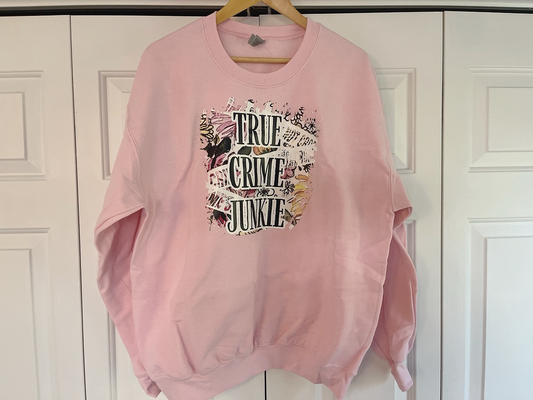 a pink sweatshirt hanging on a white door