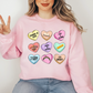 a woman wearing a pink sweatshirt with hearts on it