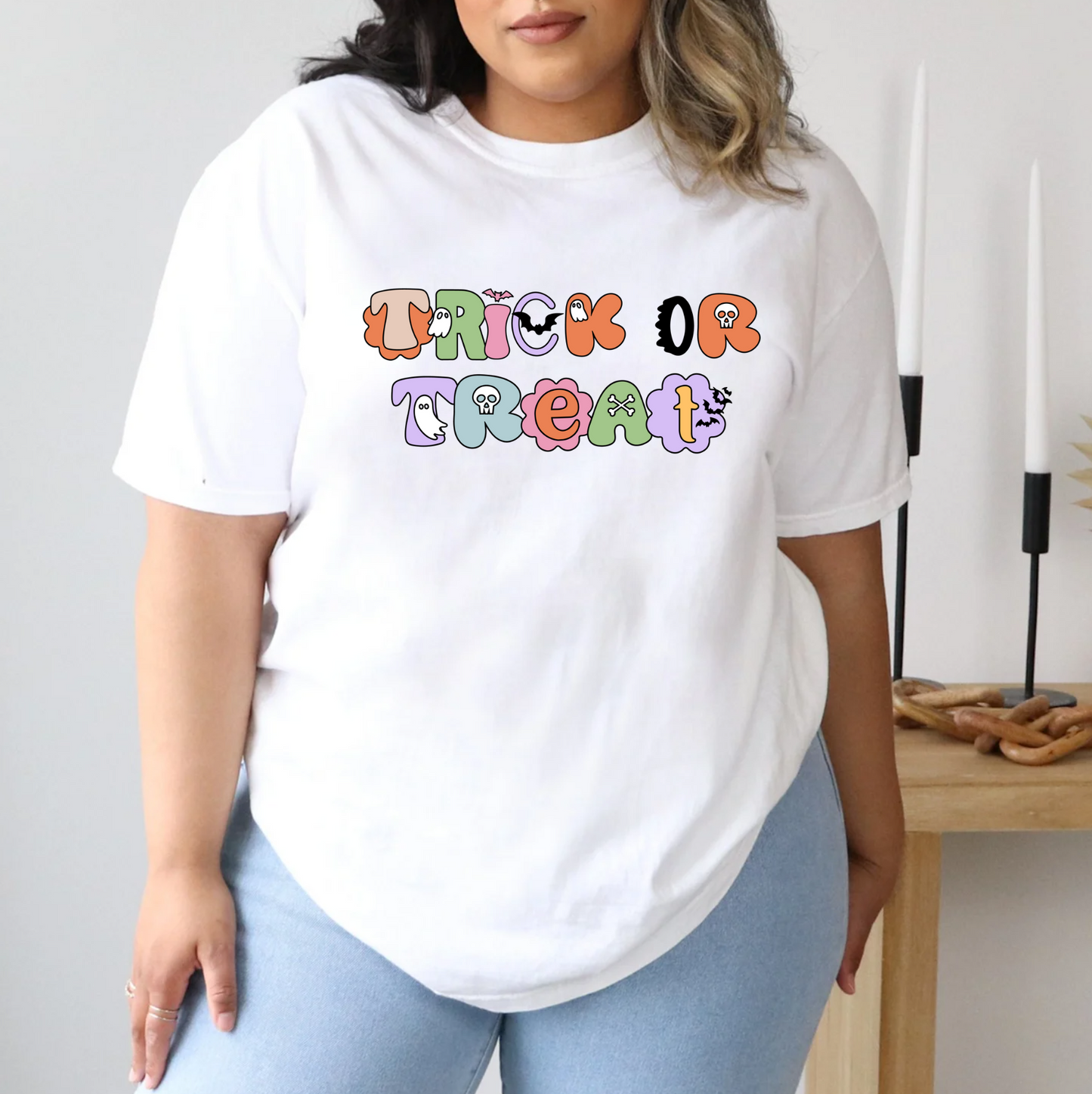 a woman wearing a white shirt that says trick or treat