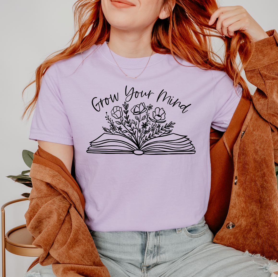 a woman wearing a t - shirt that says grow your mind