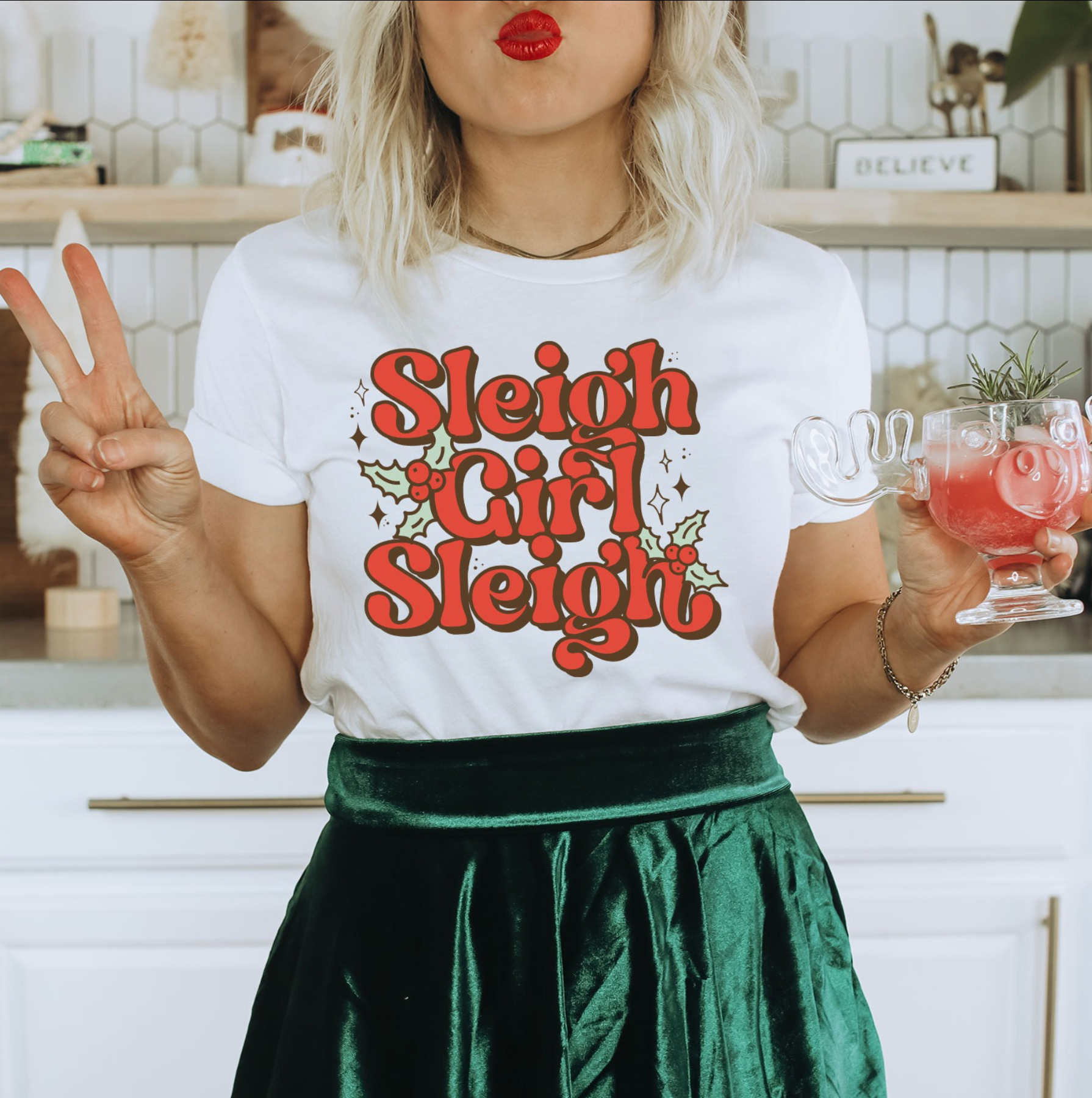 a woman in a white shirt is holding a drink