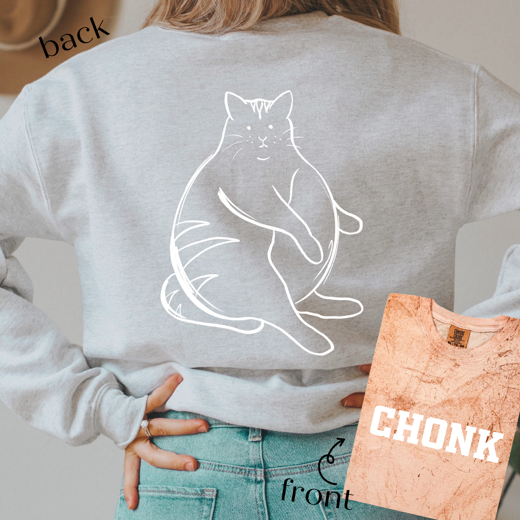 a woman wearing a gray sweatshirt with a cat on it