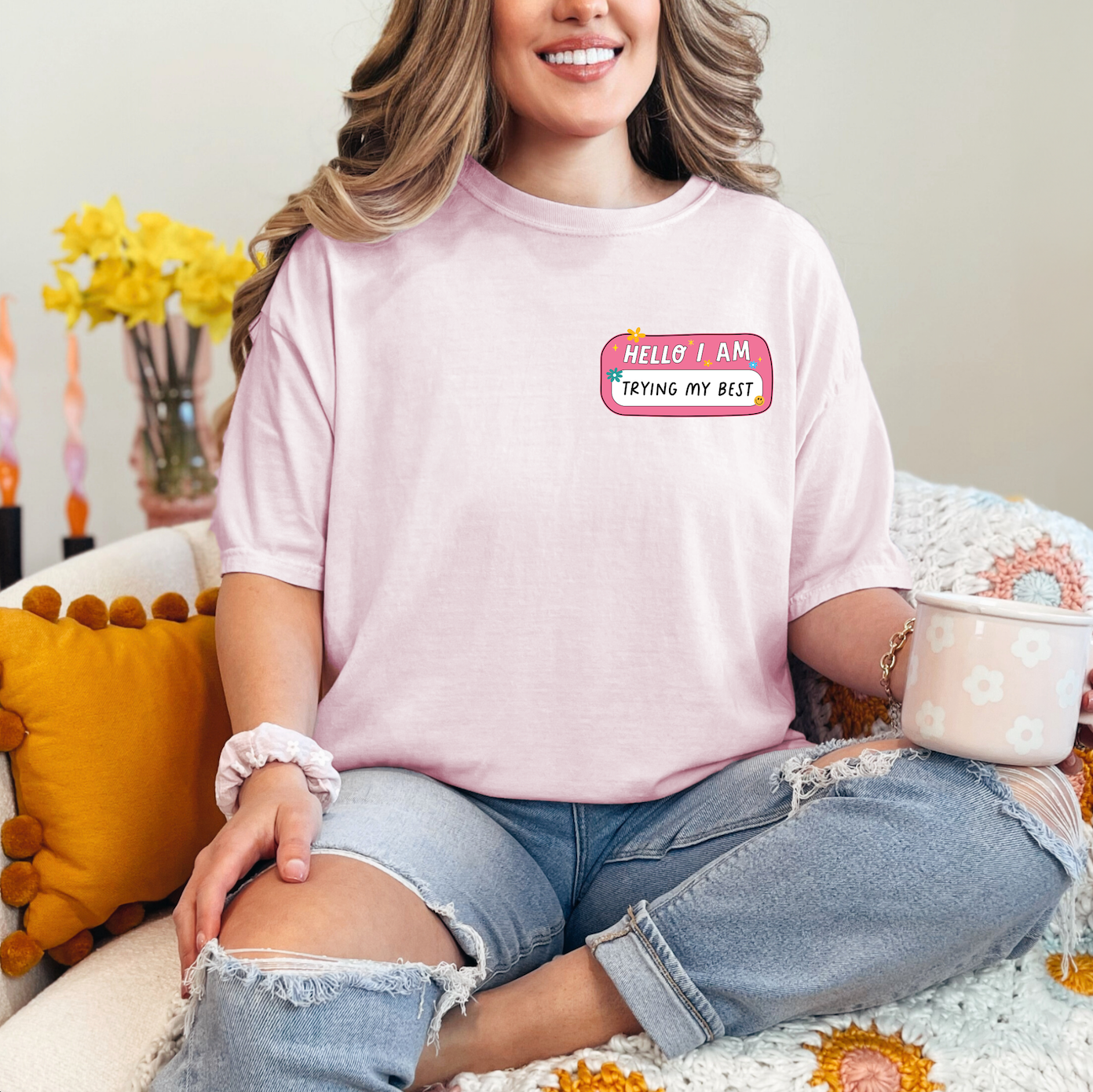 a woman sitting on a couch with a cup of coffee