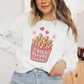 a woman wearing a white sweatshirt with fries before guys on it