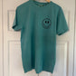 a green t - shirt with a smiley face drawn on it