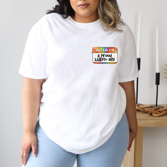 a woman wearing a white t - shirt with a rainbow sticker on it