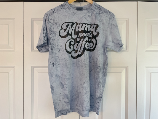 a t - shirt that says mama needs coffee hanging on a door