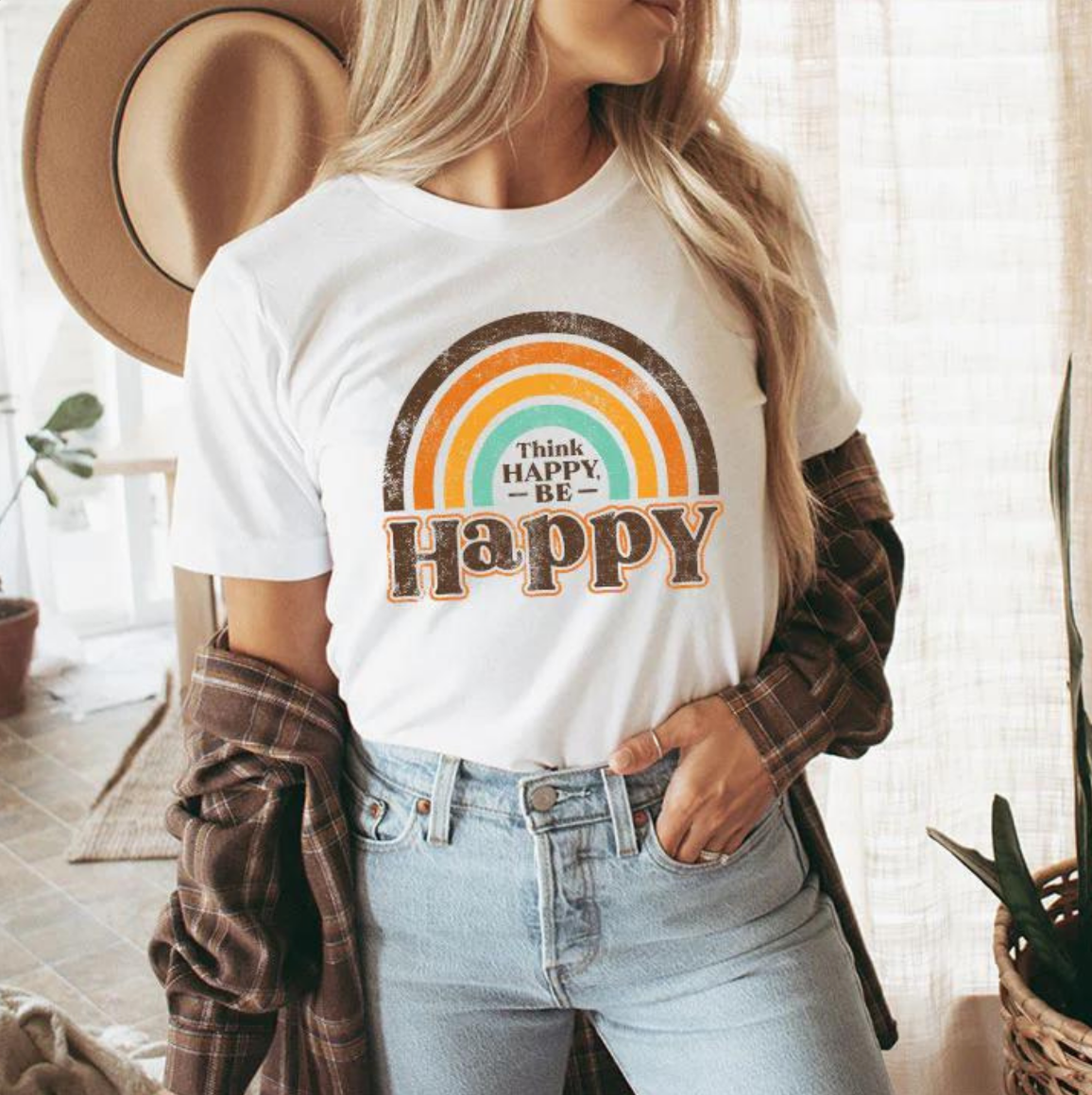 a woman wearing a t - shirt that says think happy