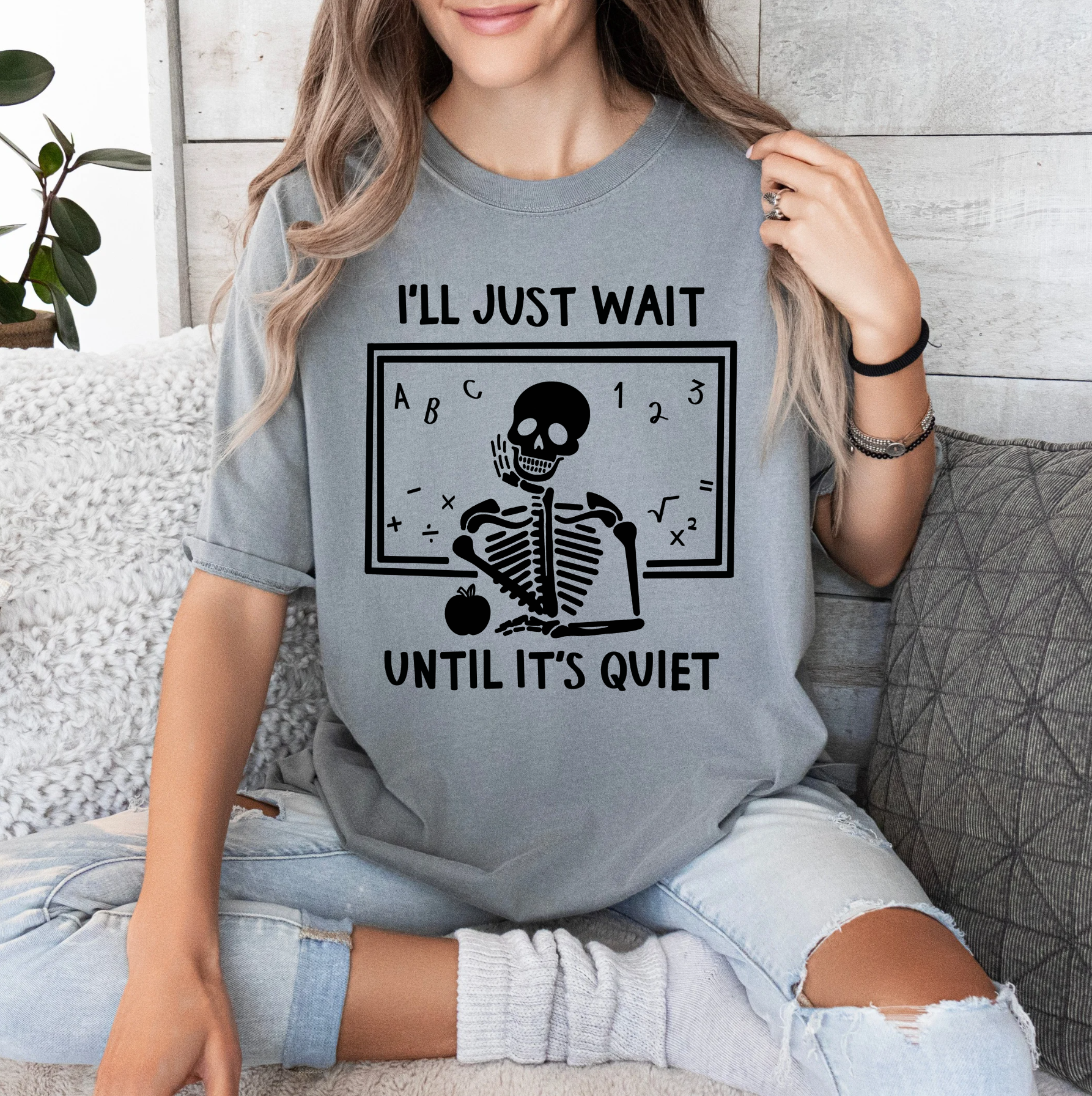 a woman sitting on a couch wearing a t - shirt that says i'll