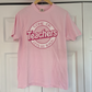 a pink t - shirt hanging on a white door