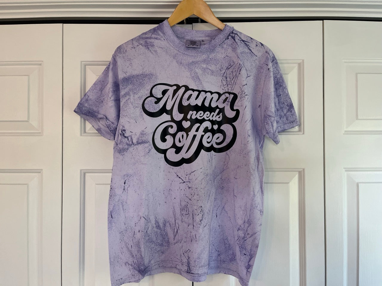 a purple shirt that says mama needs coffee on it