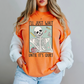 a woman wearing an orange sweater with a skeleton on it