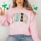 a woman in a pink sweatshirt holding up a peace sign