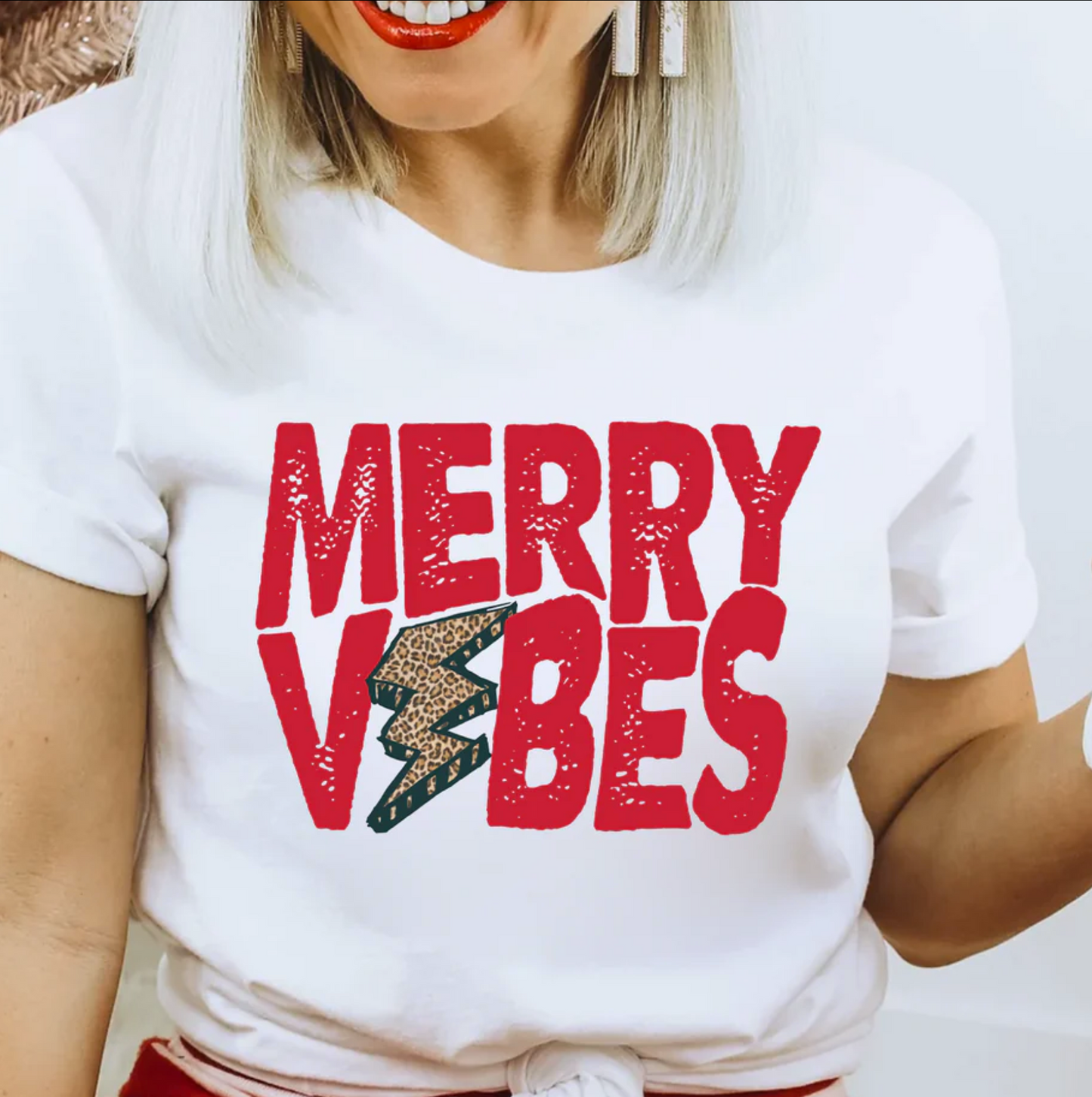 a woman wearing a merry vibes t - shirt