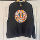 a black sweatshirt with a smiley face on it