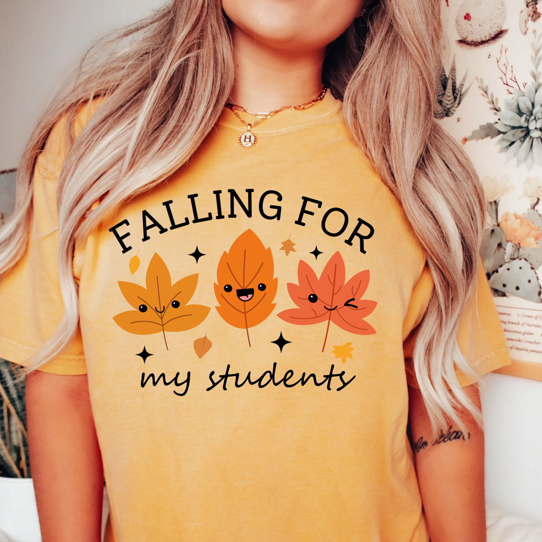 a woman wearing a yellow falling for my students t - shirt