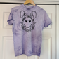 a purple t - shirt with a dog's face drawn on it