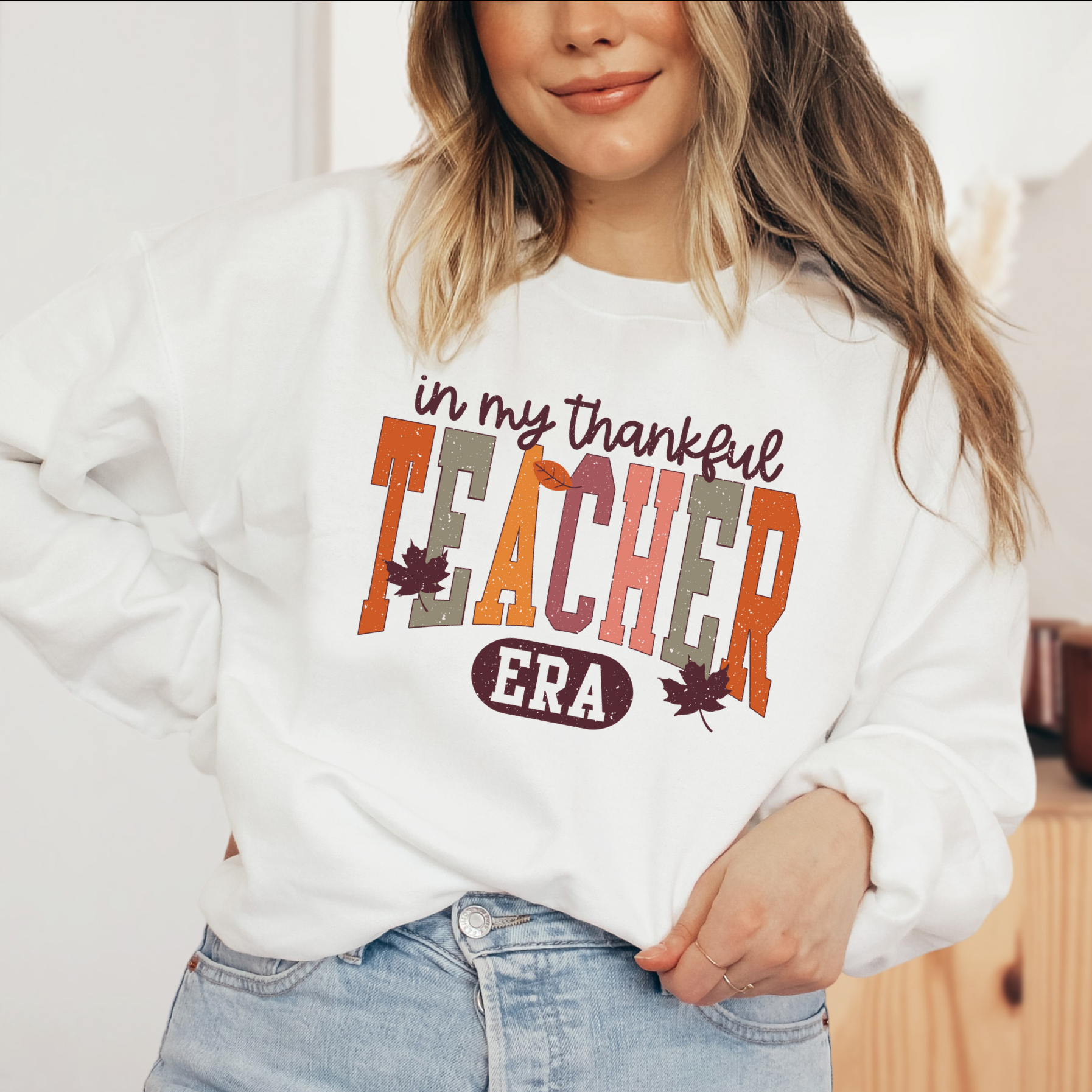 a woman wearing a sweatshirt that says in my thanksgiving teacher era