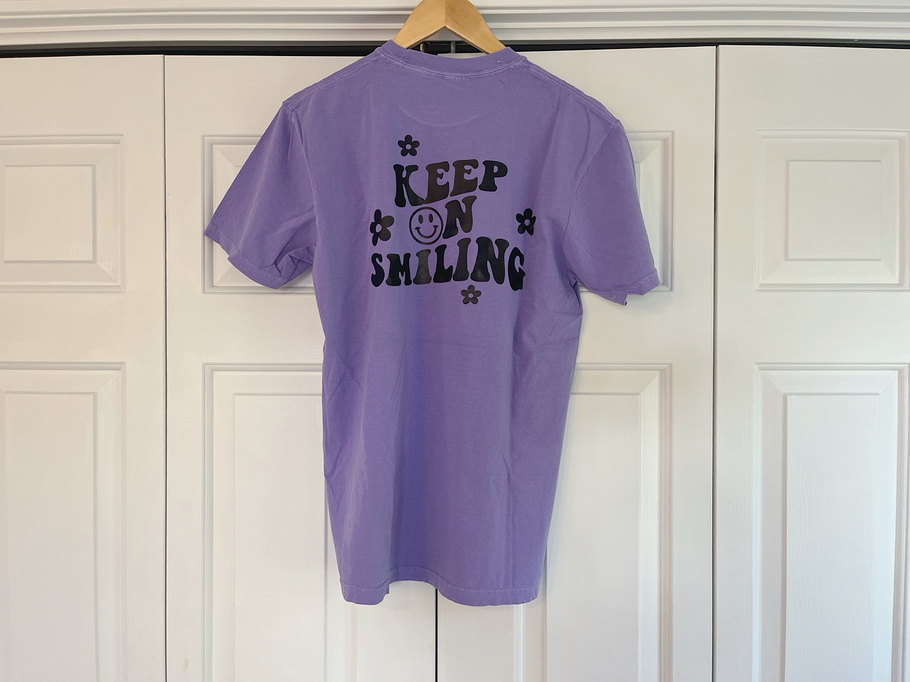 a purple shirt that says keep on selling on a hanger