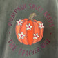 a person wearing a t - shirt with a pumpkin on it