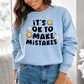 a woman wearing a blue sweatshirt that says it's ok to make mistakes