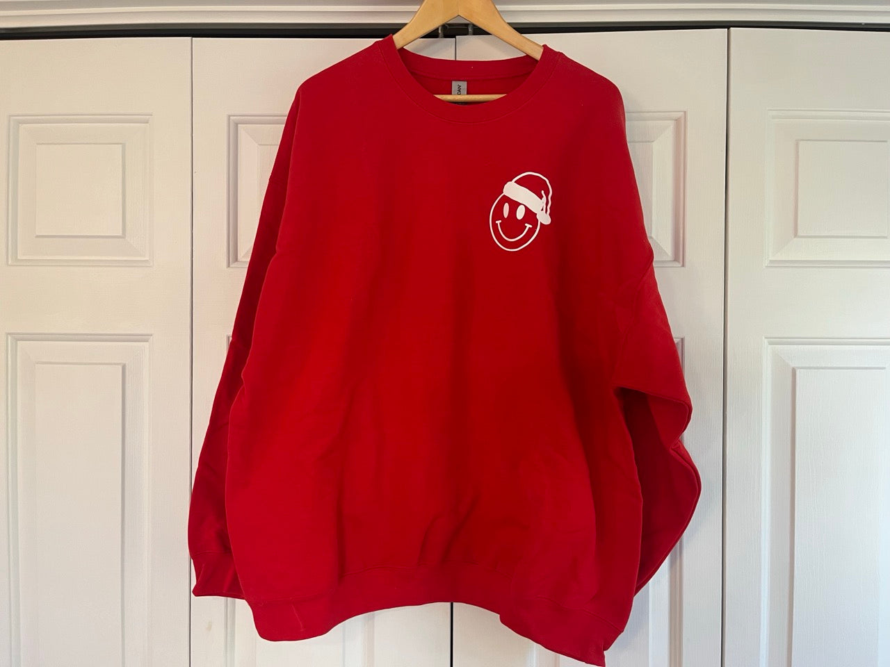 a red sweatshirt hanging on a white door