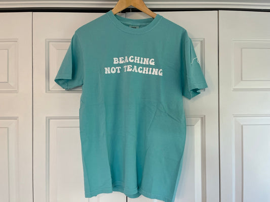 a t - shirt hanging on a hanger in front of a door