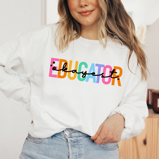 a woman wearing a white sweatshirt with the word educator on it